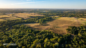 Aerial showing fenced pasture edges and tree-lined creek bottoms on Lost Creek 158