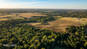 Aerial showing fenced pasture edges and tree-lined creek bottoms on Lost Creek 158