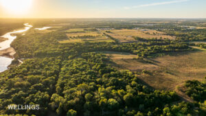 Aerial showing fenced pasture edges and tree-lined creek bottoms on Lost Creek 158