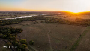 Drone aerial highlighting Lost Creek running north–south through wooded corridor and open land on Lost Creek 158