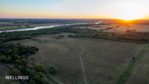 Drone aerial highlighting Lost Creek running north–south through wooded corridor and open land on Lost Creek 158