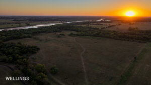 Drone aerial highlighting Lost Creek running north–south through wooded corridor and open land on Lost Creek 158