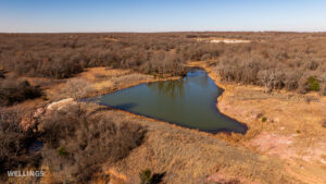 Stocked pond shoreline with wildlife habitat at The Floyd Ranch, OK
