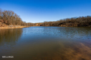 Stocked pond shoreline with wildlife habitat at The Floyd Ranch, OK