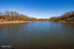 Stocked pond shoreline with wildlife habitat at The Floyd Ranch, OK